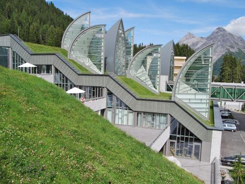 Pitched green roof with lawn and sail-shaped skylights